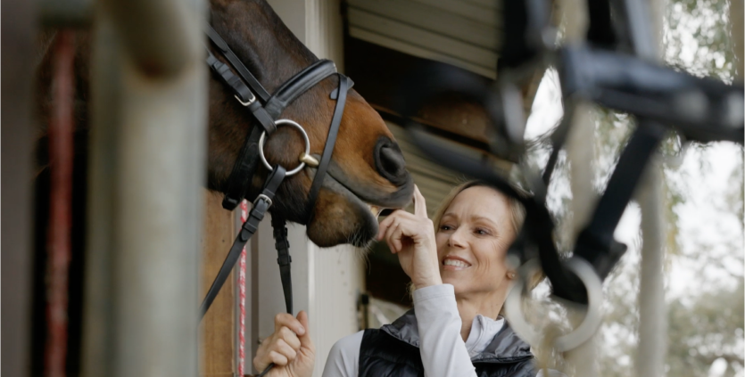 Woman petting horse. Play video